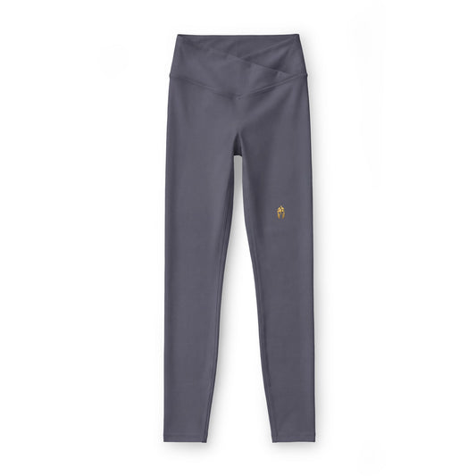 Charcoal women's performance legging with a small gold Helm helmet on the left hip
