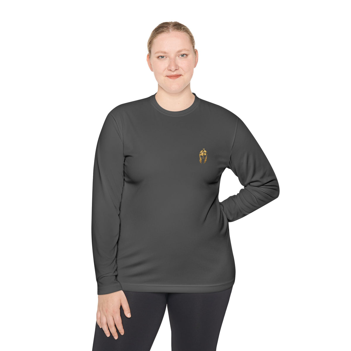 Woman wearing iron grey performance long sleeve with the gold Helm helmet on the chest