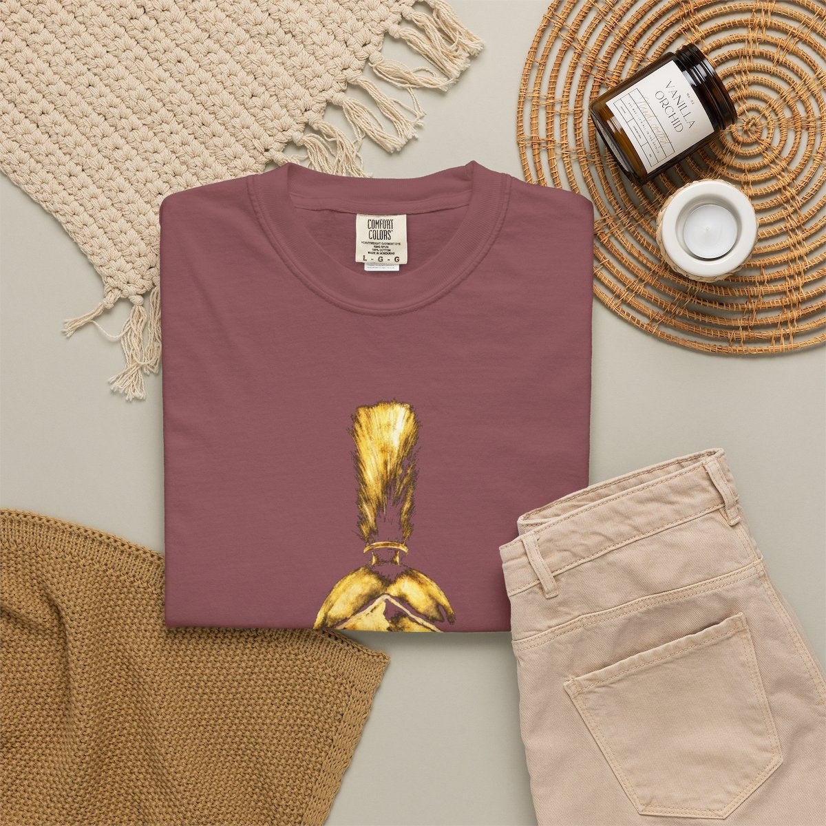 Brick casual tee folded in a flat-lay, gold Praetorian helmet on the front